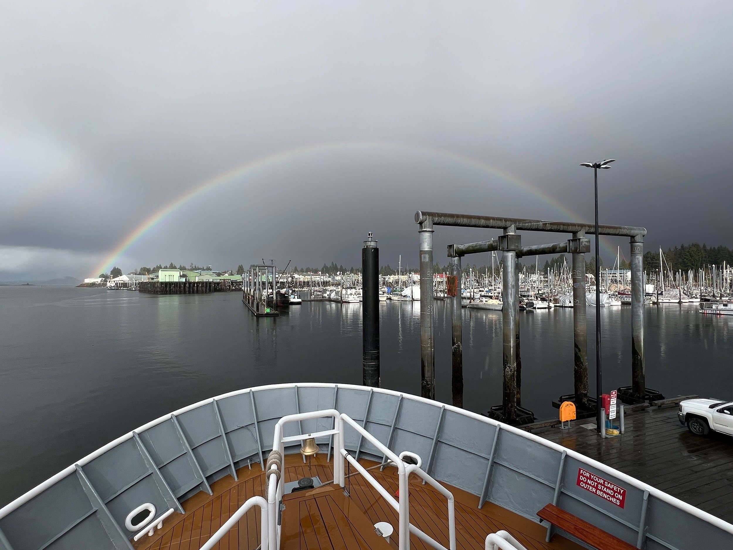 rainbow with ship bow in foreground