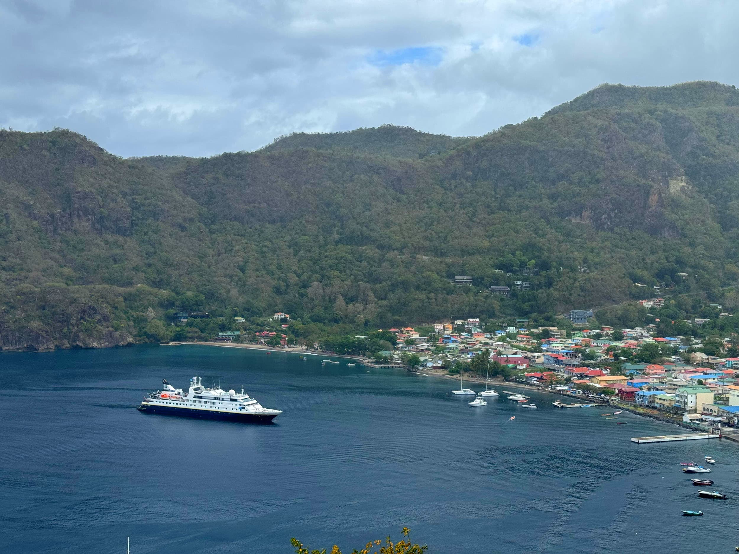 an aerial view of Soufriere, St. Lucia with a ship in the harbor