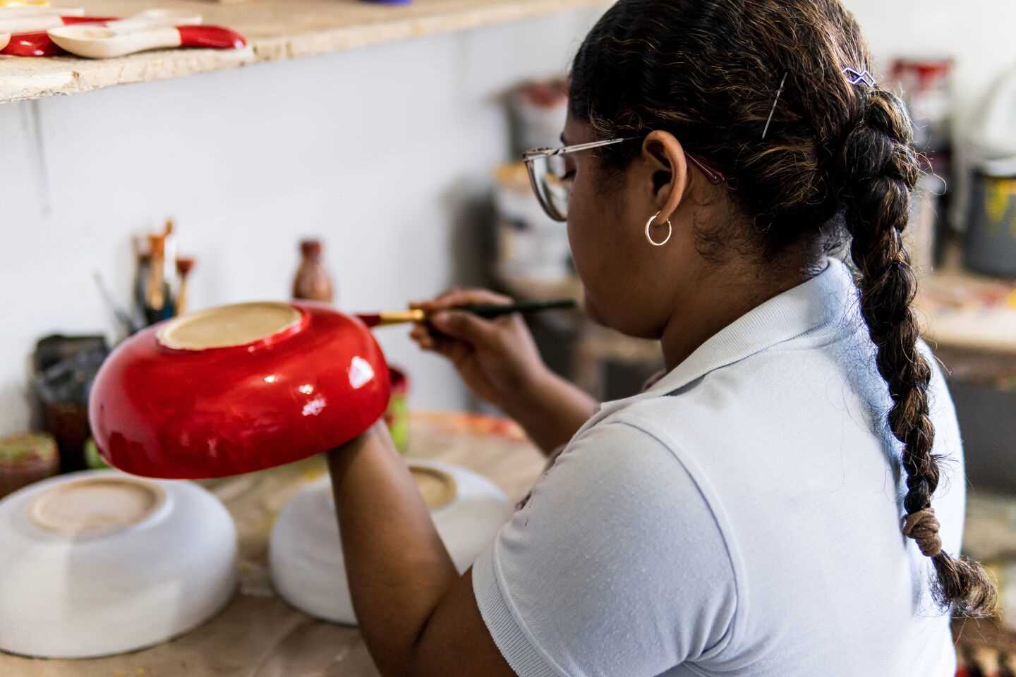 woman painting pottery