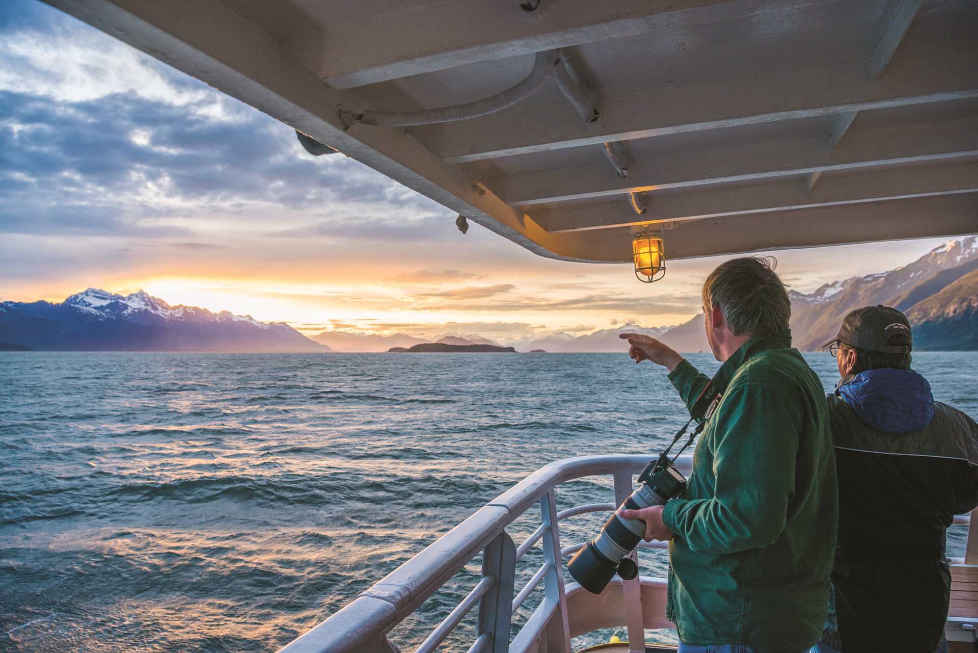 Guests photograph the sunset in Haines, Alaska.