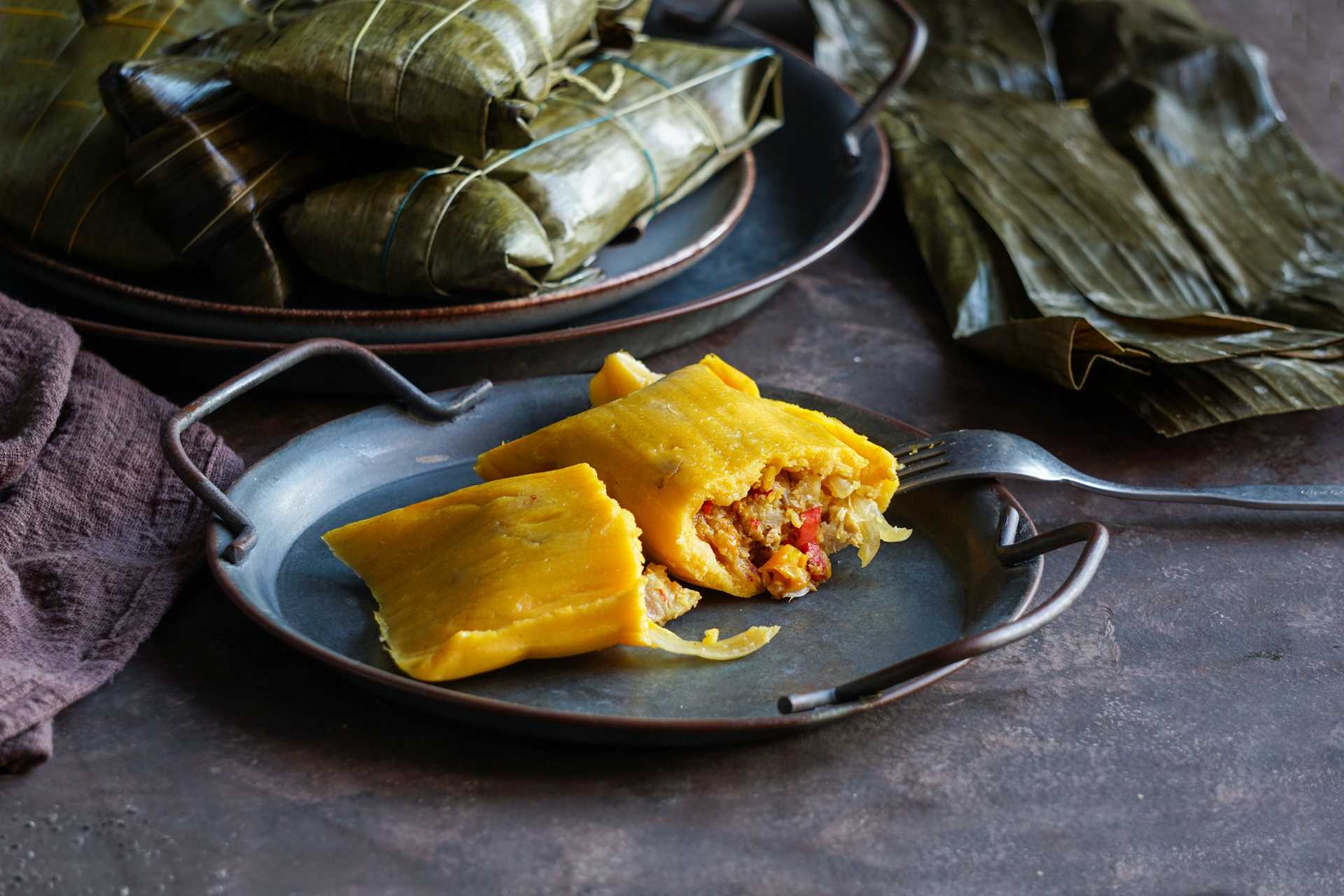 An unwrapped tamale on a plate.