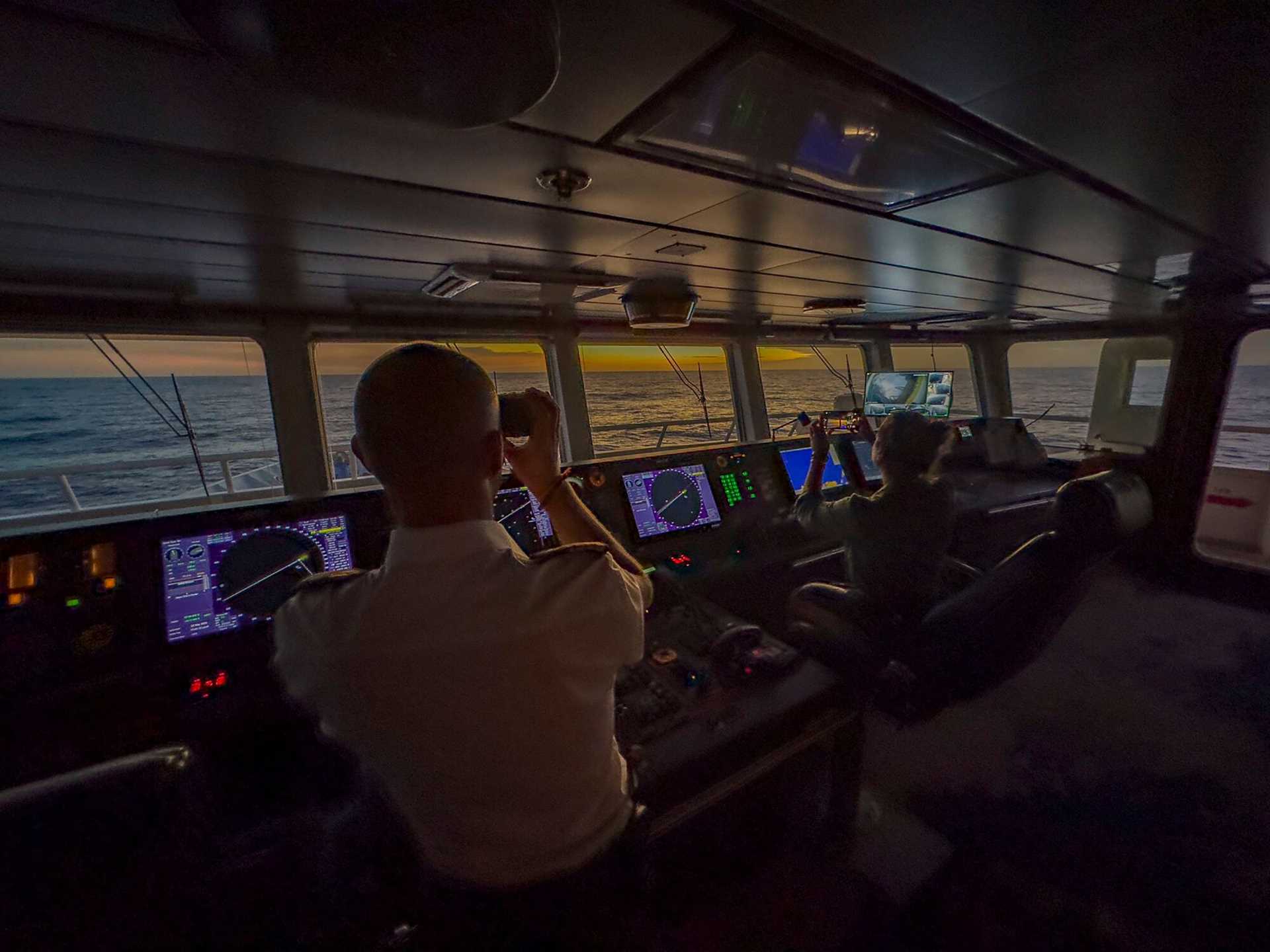 sunset on the bridge of national geographic orion