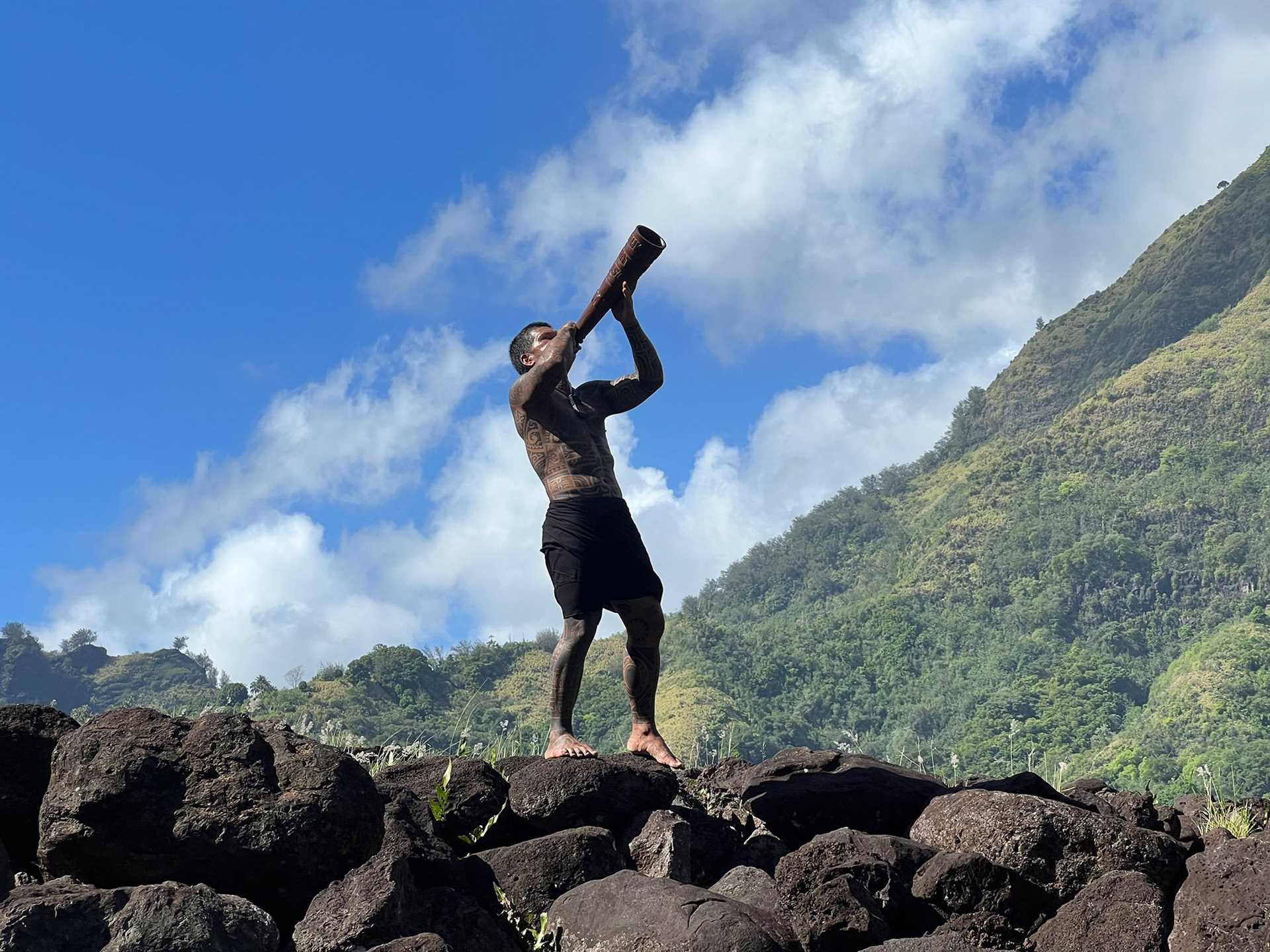 marquesan man blowing a horn