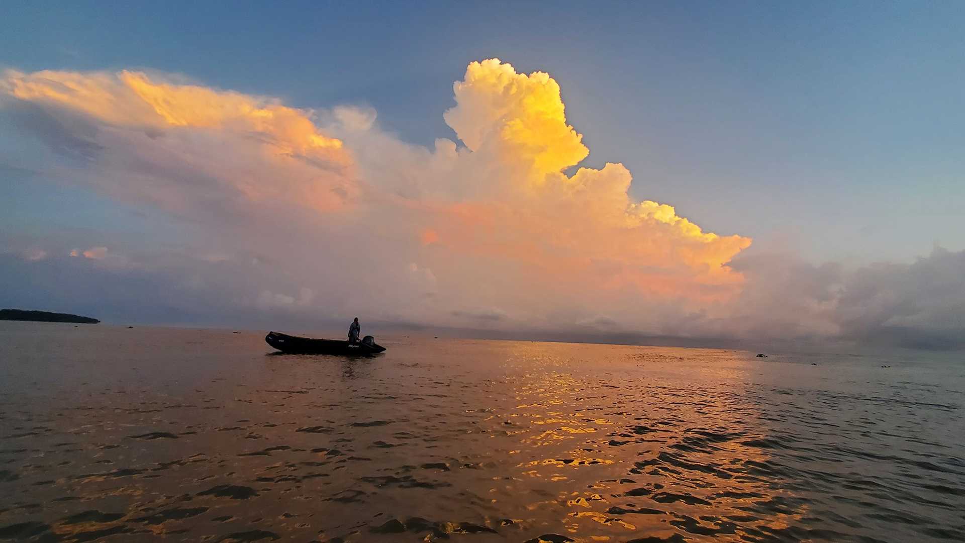 a zodiac at sunrise